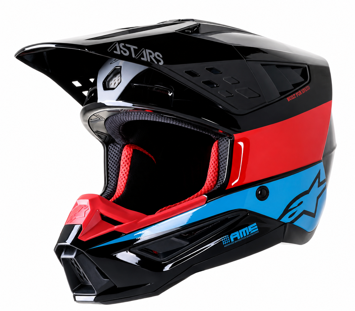 A black Alpinestars full-face motocross helmet with a bold red and blue graphic stripe, featuring a clear visor and red interior padding, shown on a white background.