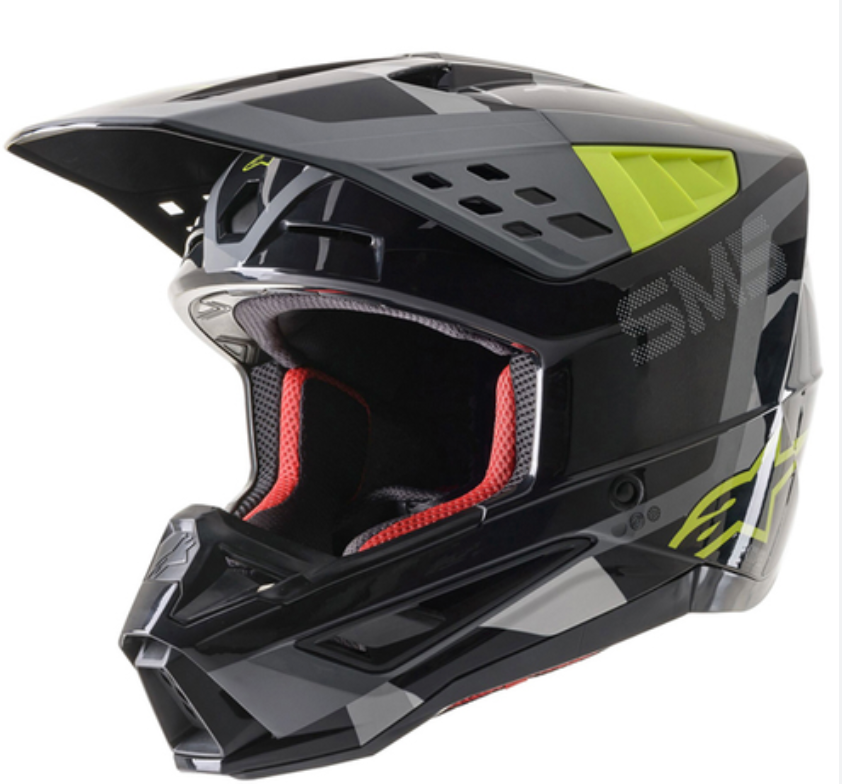 A black full-face motocross helmet with gray graphics and bright neon yellow-green accents, including a visor and side details. The interior padding is red.