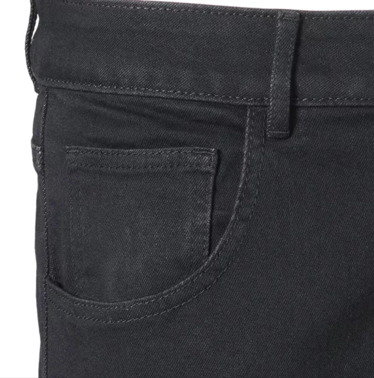 Close-up detail of black denim jeans showing the back pocket, belt loop, and waistband stitching.